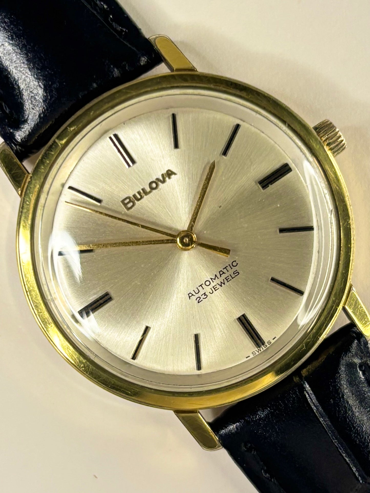 1960s Bulova dress watch timepiece with a white sunburst dial and gold-plated case, shown in great condition as a refined vintage timekeeper.
