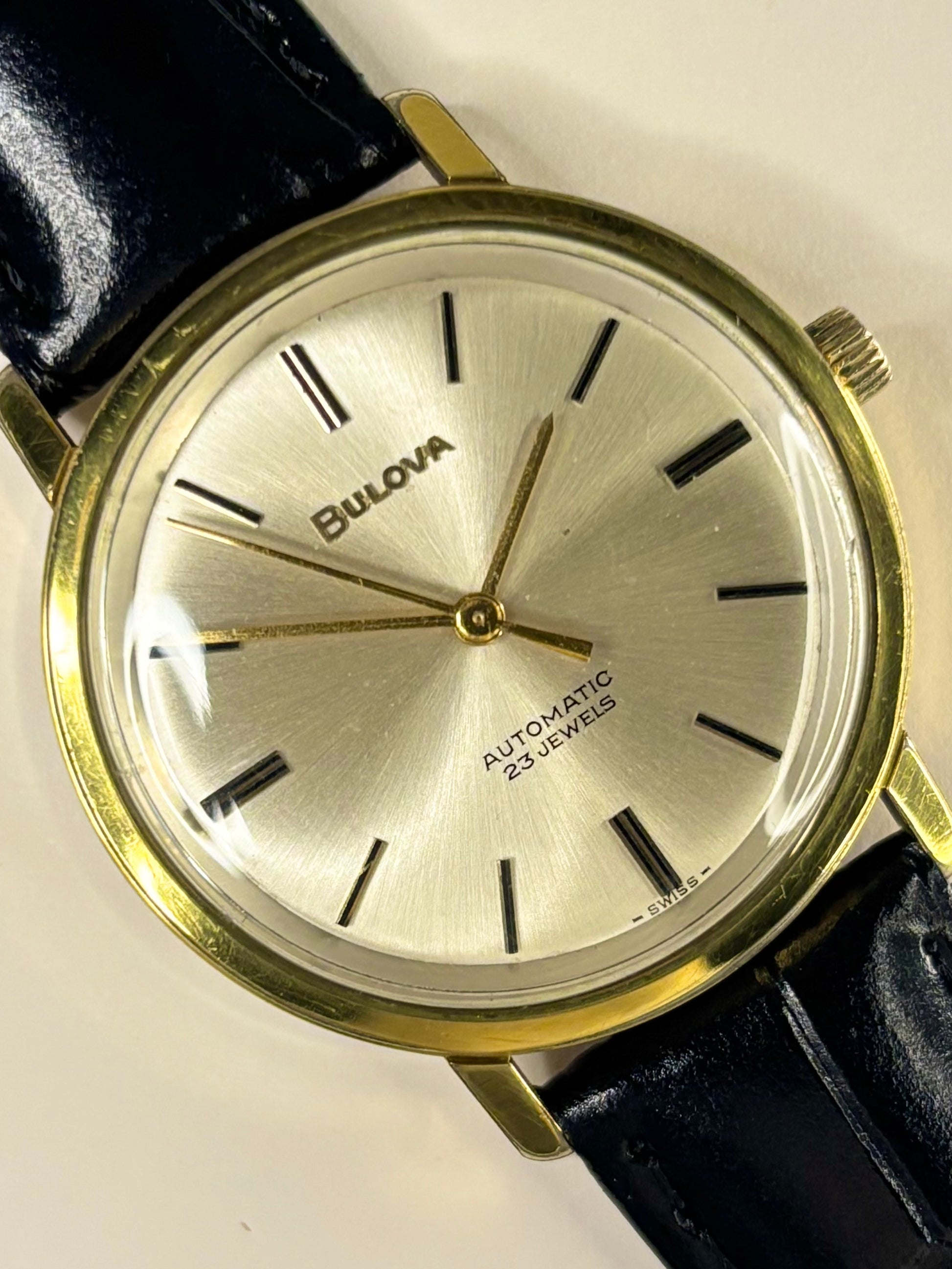 1960s Bulova dress watch timepiece with a white sunburst dial and gold-plated case, shown in great condition as a refined vintage timekeeper.