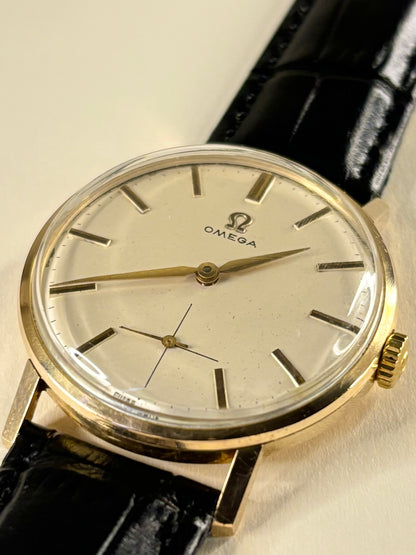Close up of Omega 1960s gold dress watch sub-seconds dial vintage manual