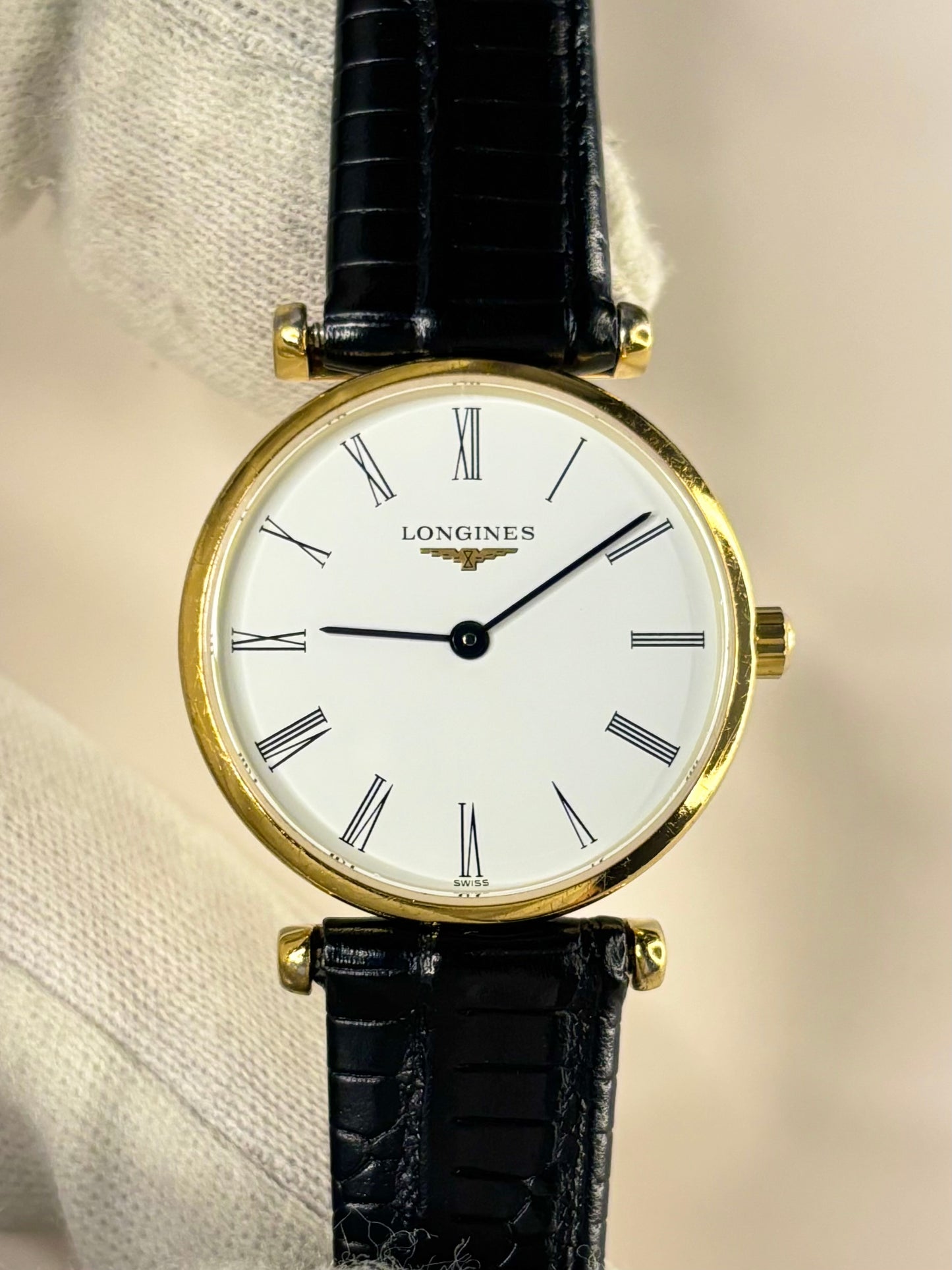 Close-up of a vintage Longines ladies timepiece featuring movement number L4.209.2, with a white dial and gold-plated case, shown as an elegant 1990s timekeeper in great condition.