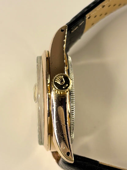 Side profile of Tudor Ref. 7919 men’s vintage 1959 timekeeper with slim rose gold plated case styling Rolex signed crown