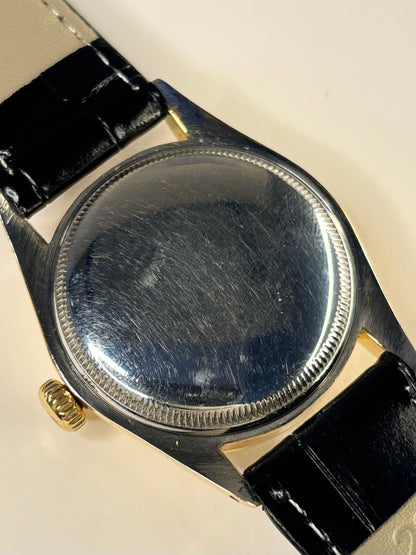 1950s Rolex dress watch model 6285 with textured dial and gold-plated case, automatic movement. caseback view 
