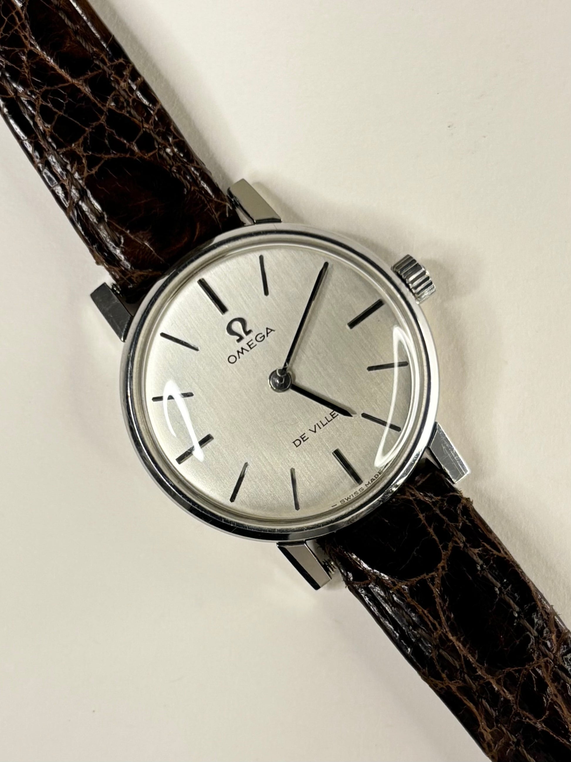Omega De Ville ladies timepiece with silver-toned dial and stainless steel case, presented as a classic vintage timekeeper