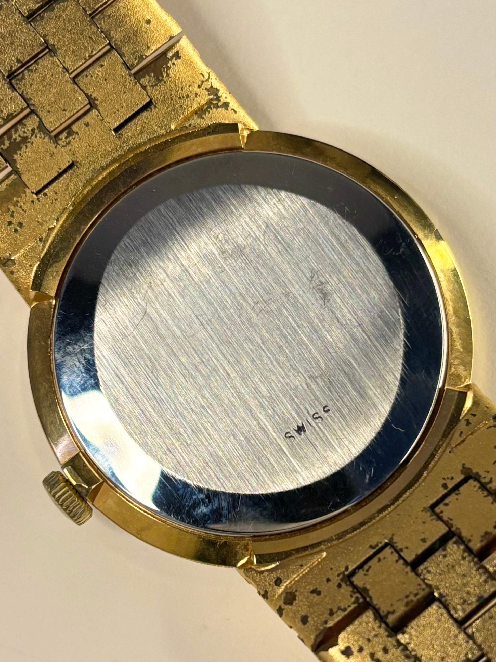 Caseback of Rotary vintage manual wind watch with 35mm case and bark effect strap