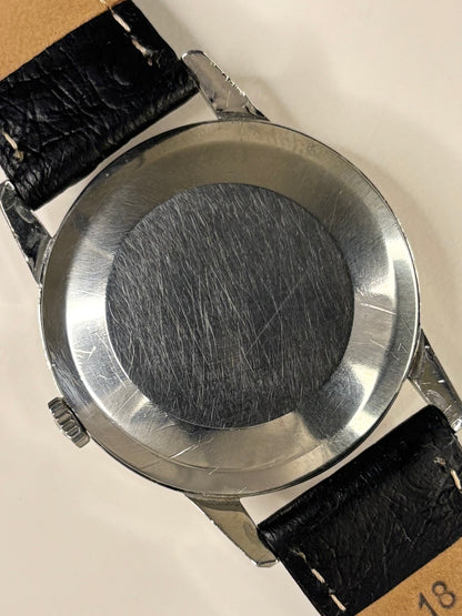 Omega Ref. 1961 stainless steel 1961 men’s dress timekeeper caseback view with hallmark details