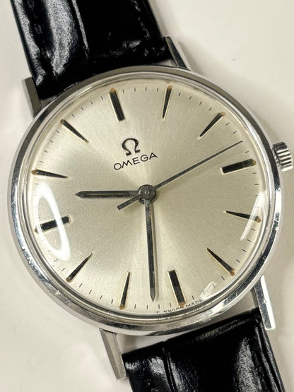 Collectible Omega Ref. 131.018 men’s 1964 vintage dress timekeeper featuring white sunburst dial and refined Swiss craftsmanship
