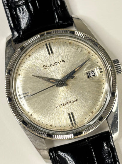 Close up of Bulova 1960 vintage men’s watch white sunburst dial