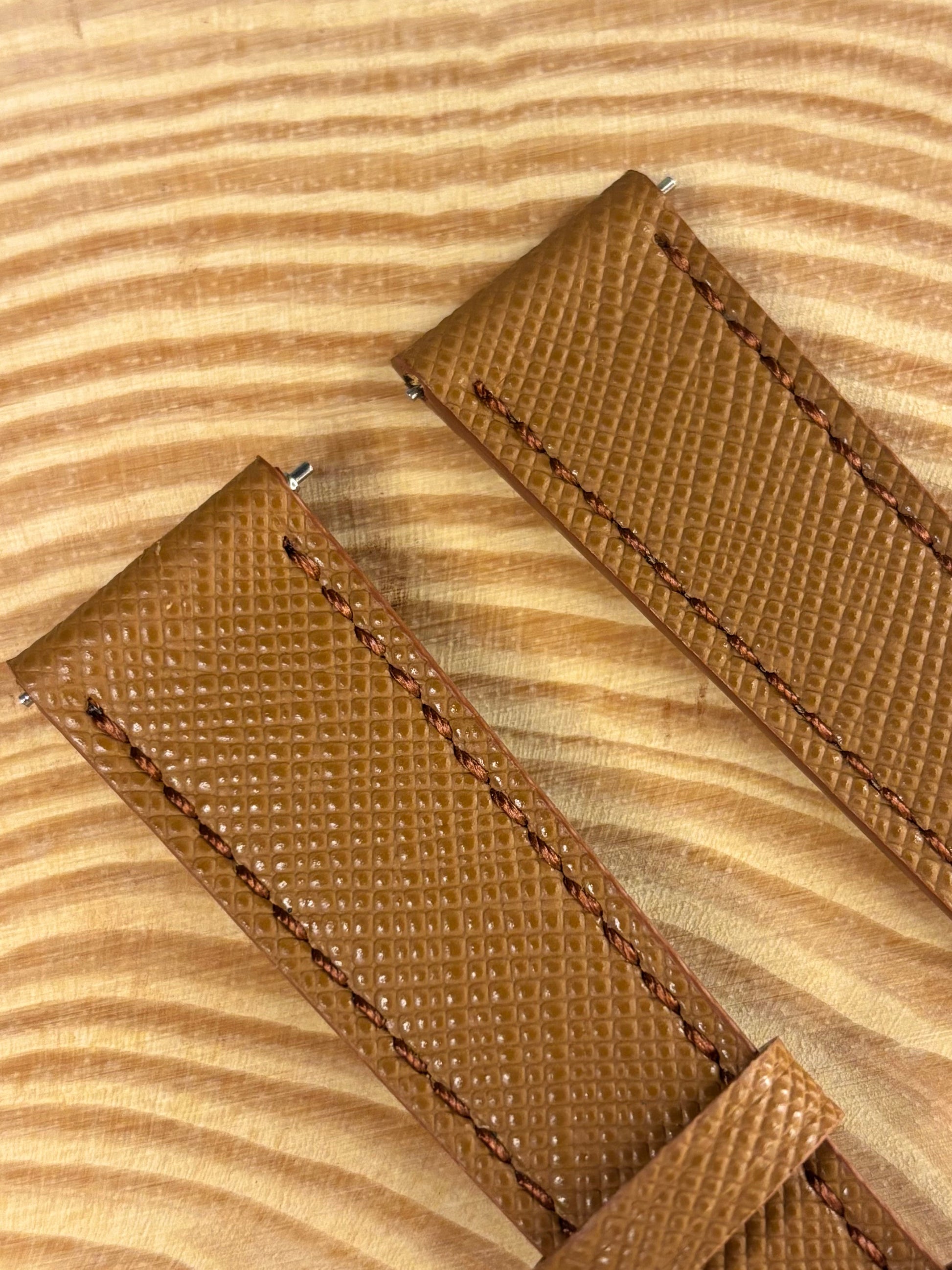 Premium handmade luxury brown Saffiano leather watch strap showing structured crosshatch texture