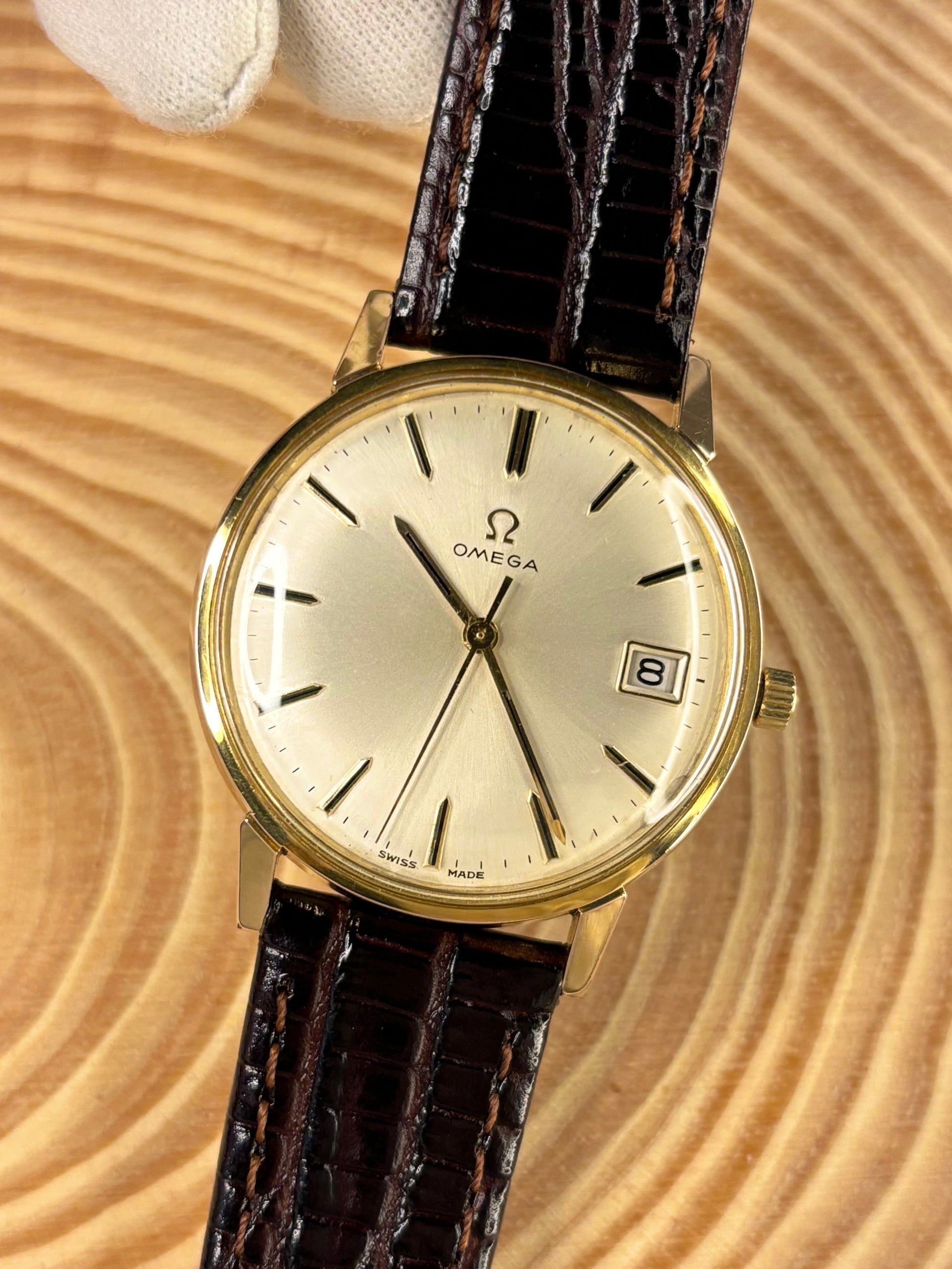 Handmade premium luxury brown Teju lizard grain leather strap highlighting detailed texture seen on a vintage omega dress watch