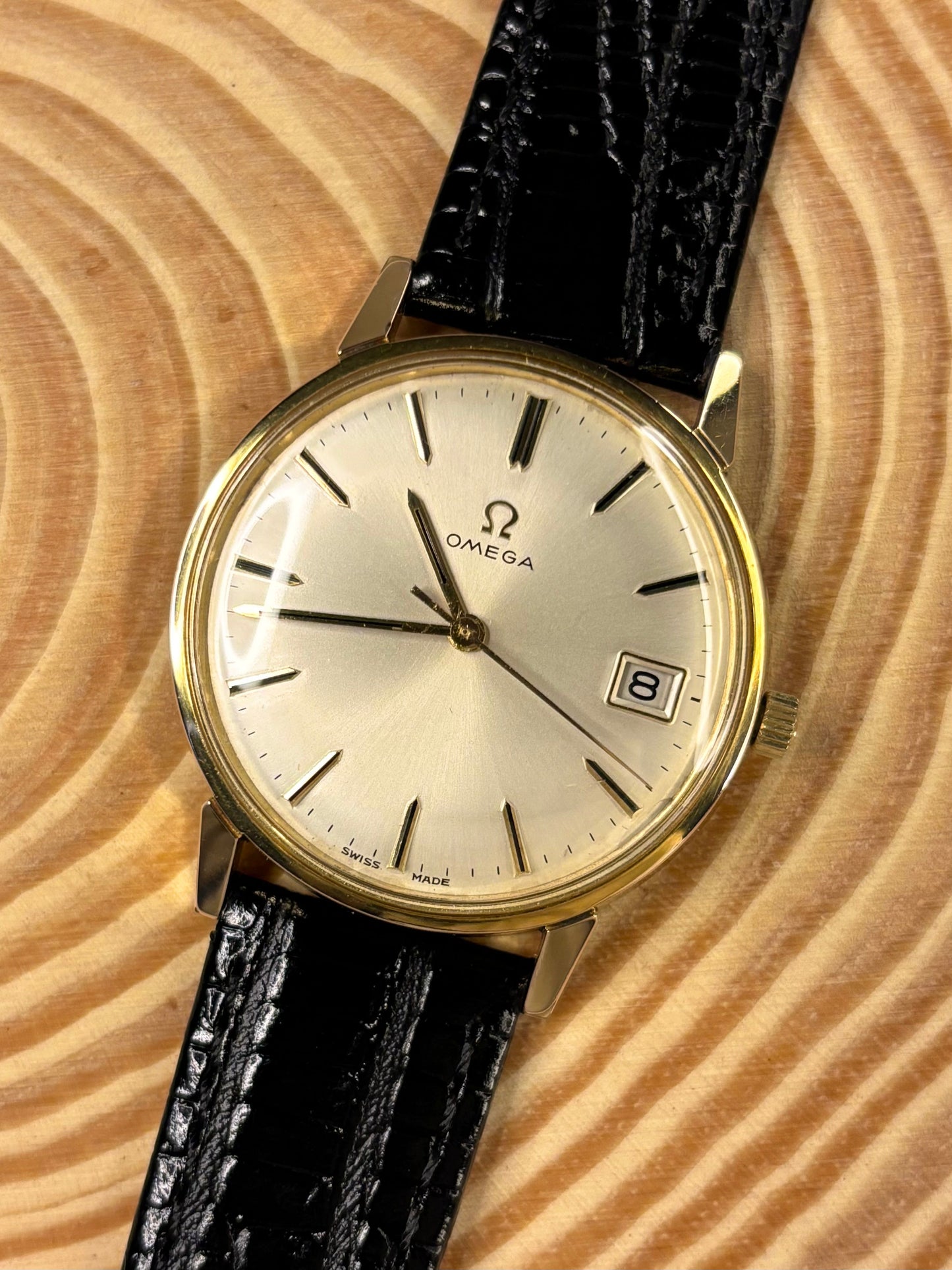 Handmade premium luxury black Teju lizard grain leather strap highlighting detailed texture seen on a vintage omega dress watch